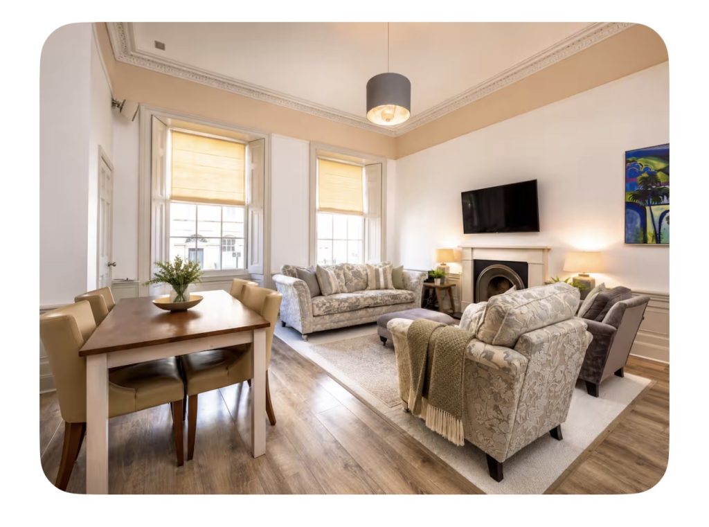 New Town Apartment 2 Living room with fireplace, TV and artwork at The City Apartments Edinburgh